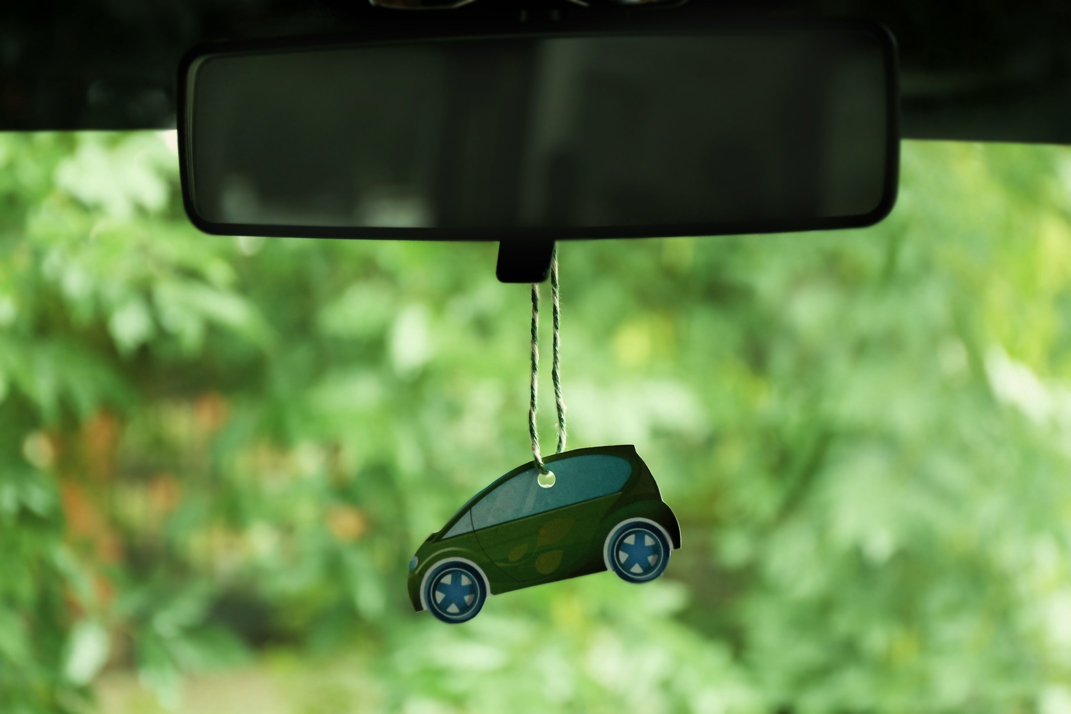 Air freshener shaped like SUV hanging from rear view mirror